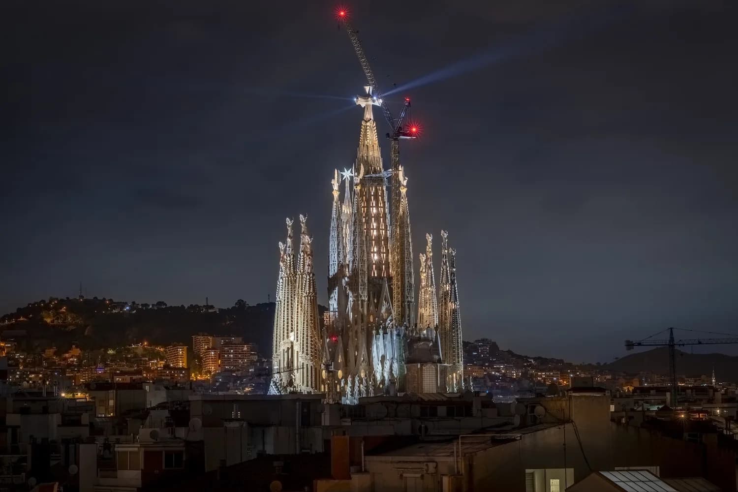 Sagrada Família lit at night after its central tower reached full height in 2026
