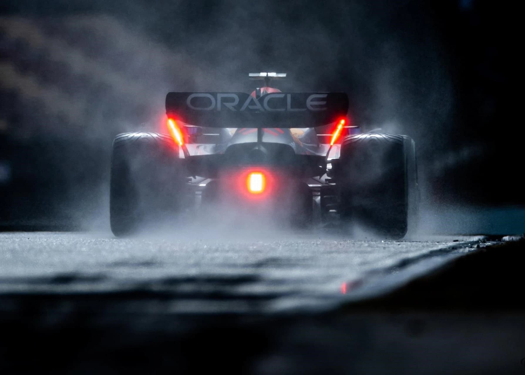 Red Bull Formula One car racing in rain